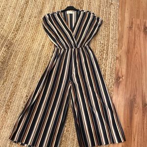 Multi-colored pleated romper with a cinched waist. Size S.